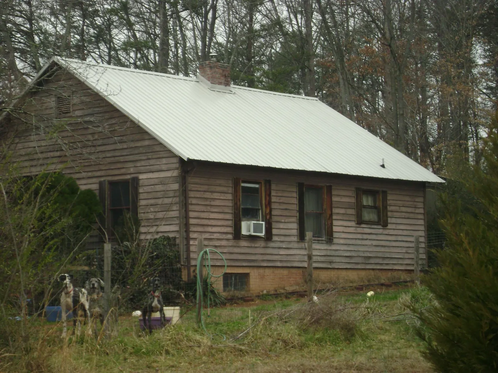 White metal roof on an old wood sided farmhouse, from a Metal Roof Installation job in Blakely